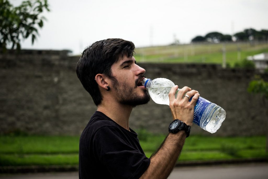 man-wearing-black-shirt-drinking-water-907865
